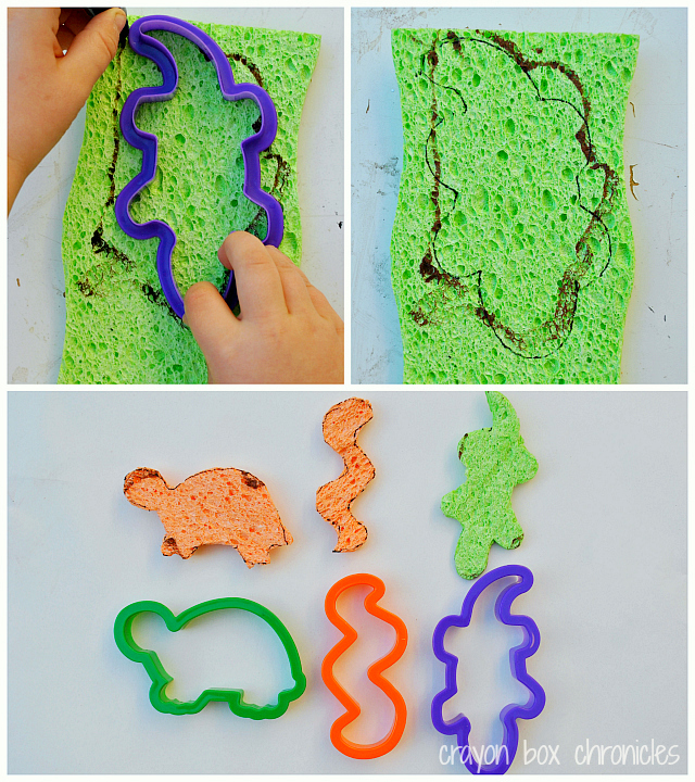 Prepare your paper, taping down the edges. Next, draw the letter R on your paper in glitter glue. While the R is drying, prepare reptile sponges.