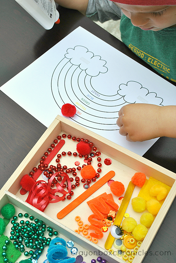child making a rainbow collage from loose materials