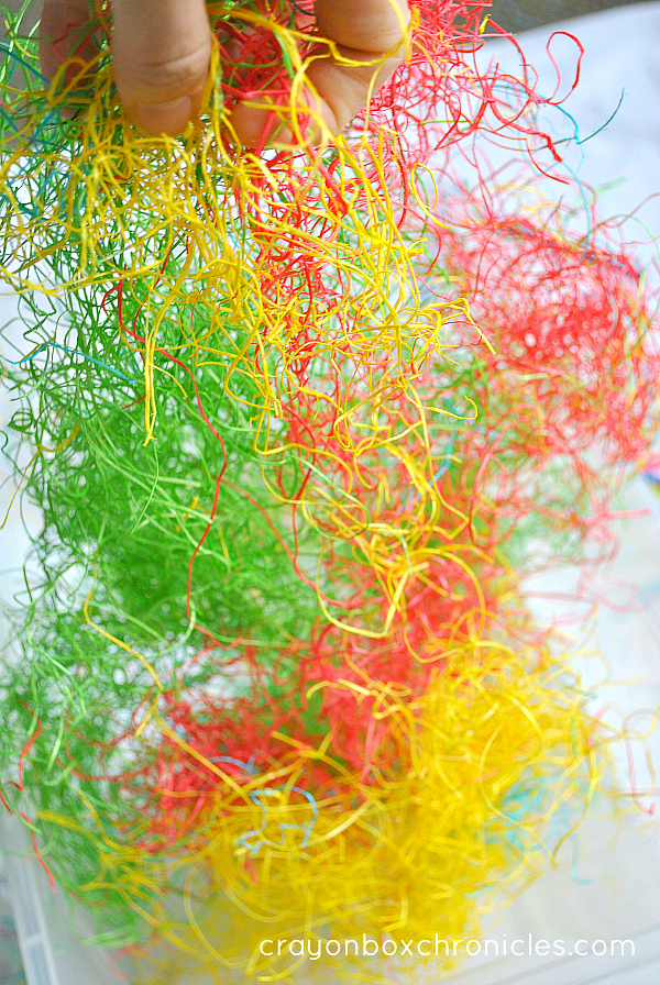 pulling apart colored hay